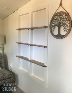 a living room with shelves and a chair