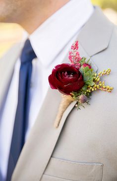 a man in a suit with a boutonniere on his lapel