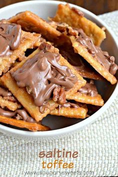 a bowl filled with chocolate covered waffles on top of a table