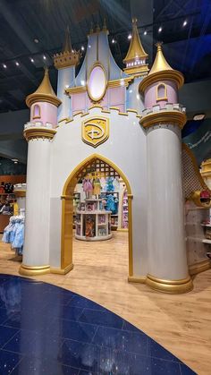 the inside of a toy store with an archway and castle like structure in it's center