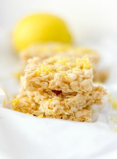 two pieces of food sitting on top of a white table cloth next to a lemon