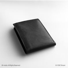 Genuine leather for unmatched durability and style. Slim bifold design fits easily in pockets without bulk. Multiple card slots and a spacious bill compartment. Perfect gift for any occasion, combining elegance and function. Discover the perfect blend of style and functionality, Genuine Leather Men's Bifold Wallet. Designed for the modern man, this slim and durable wallet is made from premium leather, ensuring long-lasting quality. It features multiple card slots and a spacious bill compartment, making it an ideal choice for daily use. Whether as a gift or for personal use, this wallet combines elegance with practicality. Classic Black Trifold Wallet For Everyday Carry, Classic Black Trifold Wallet For Everyday, Durable Bifold Wallet For Everyday Use, Bifold Wallets For Daily Use, Classic Black Trifold Wallet For Daily Use, Durable Black Wallet, Formal Leather Bifold Wallets, Modern Black Trifold Wallet, Minimalist Black Bifold Wallet