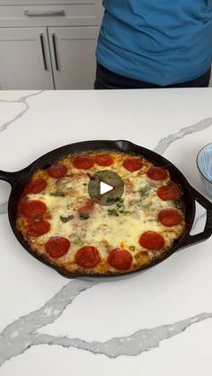 a pizza sitting in a pan on top of a counter