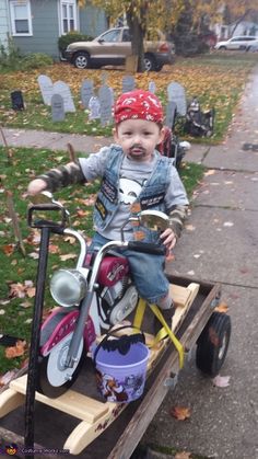 a small child riding on top of a wooden cart