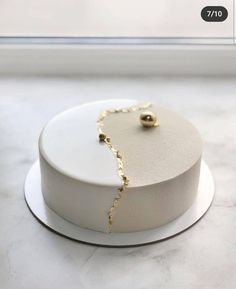 a white cake topped with a gold chain