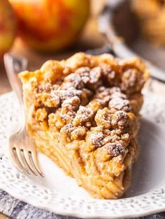 a slice of apple pie on a plate with a fork