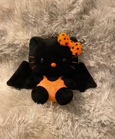 a black and orange kitty cat stuffed animal