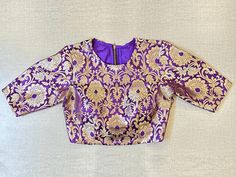 Shop beautiful purple Banarasi saree blouse online in USA. Elevate your saree style with exquisite readymade saree blouses, embroidered saree blouses, Banarasi saree blouse, designer saree blouse, choli-cut blouses, corset blouses from Pure Elegance Indian clothing store in USA.-full view Festive Long Sleeve Choli With Zari Weaving, Fitted Gold Banarasi Silk Blouse Piece, Long Sleeve Banarasi Silk Choli With Pallu, Traditional Designer Purple Blouse Piece, Traditional Purple Blouse Piece For Designer Wear, Traditional Purple Blouse Piece With Self Design, Fitted Purple Traditional Wear With Zari Weaving, Fitted Brocade Traditional Wear With Motifs, Traditional Purple Self-design Blouse Piece