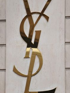 a gold and black sign on the side of a building