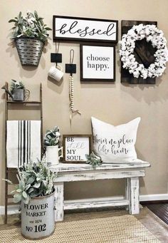 a white bench sitting in front of a wall filled with pictures and plants on it