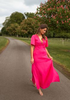 Effortless charm meets feminine flair. This pink dress boasts short sleeves, a bow at the bust, and subtle splits at the bottom. It also features a back zipper for convenience and a flowy silhouette for comfort. Though it is unlined, the dress not sheer. Sizes: S-M / M-L S-M: Length 51.97 in - Width 13.39 in M-L: Length 52.26 in - Width 14.17 in 100% polyester Washing: handwash only Pink Short Sleeve Midi Dress For Party, Pink Short Sleeve Party Midi Dress, Chic Short Sleeve Maxi Dress For Bridesmaids, Feminine Pink Midi Dress With Flutter Sleeves, Feminine Short Sleeve Maxi Dress For Evening, Pink Fitted Midi Dress With Flutter Sleeves, Feminine Short Sleeve Dresses, Pink Flutter Sleeve Midi Dress For Party, Pink Short Sleeve Midi Dress For Evening