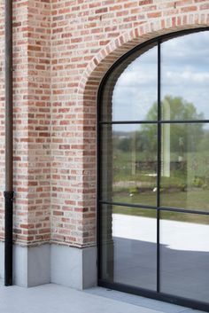 an open window on the side of a brick building