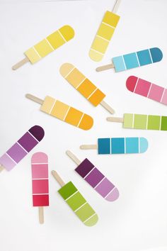 popsicles with different colors are arranged on a white surface