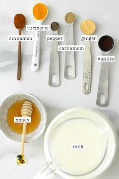 the ingredients for making homemade honey syrup on a white counter top with spoons and measuring cups