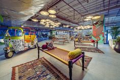 the interior of a brightly colored building with various furniture and decorations on display in it