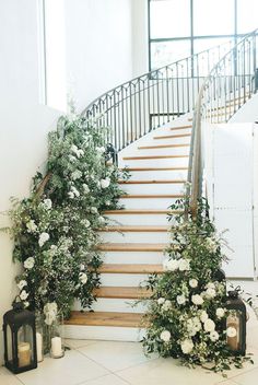 the stairs are decorated with flowers and greenery