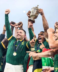 the rugby players are celebrating with their trophy