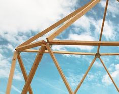 a wooden structure under a blue sky with some clouds in the backgroung