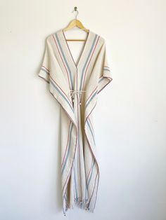 These super soft cotton tunic dresses are handmade in Sayulita, Mexico. This knee length dress is reversible can be worn with ties or without. Comes in two colors: natural white and red & blue stripe. Handmade by Quiut, Sayulita MX. One size Width - 20 ", length - 57", V-neck depth - 12" 100% natural cotton Photos with models courtesy of Quiut. Striped Long Dress For Vacation, Long Striped Vacation Dress, Cream Linen Beach Dress, Striped Linen Dress For The Beach, Striped Linen Beach Dress, Striped Linen Dresses For Vacation, Maxi Beach Dress, Cotton Tunic Dress, Tunic Dresses