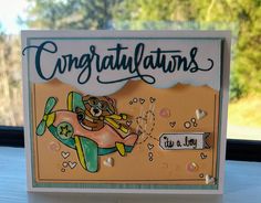 a card with an airplane and congratulations written on it