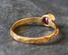 Gold Ruby Ring set with a Natural Ruby in a diamond cut, natural pettern & red color, from Burma, at 5mm diameter, 0.6 Carat. Gold Solitaire Ring design made of Gold Vermeil ☞ thickest 18k Gold Plating on top of Solid 925 Sterling Silver ☞ made to last. Matching Earrings ☞ please ask meMatching Pendant ☞ please ask meDetails:♥ Natural Ruby sourced from Burma♥ Ruby: 5mm, 0.6 Ct, diamond cut♥ Band width ≈ 2mm, thickness ≈ 1mm♥ 18K Gold Vermeil❀ Each Natural Gem is unique & will have Slight variati Solitaire Ring Designs, Ruby Eternity Band, Ruby Ring Set, Ruby Solitaire Ring, Gold Ruby Ring, Natural Ruby Ring, Ruby Bands, Ruby Ring Gold, Gold Solitaire Ring