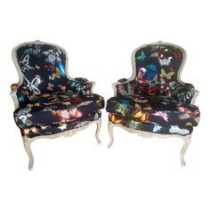 two chairs that are sitting next to each other on a white background, one is covered in butterflies