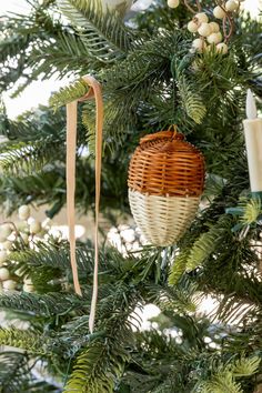 a wicker ornament hanging from a christmas tree