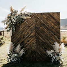 a wooden structure decorated with flowers and feathers