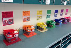 several bins are lined up on the wall in front of each other with different colors