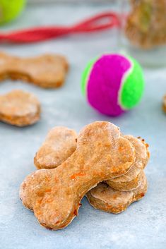 dog treats are stacked on top of each other with a ball in the back ground