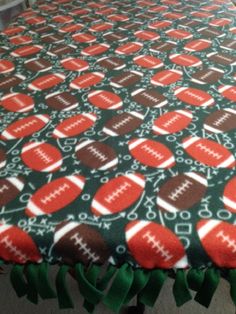 a green and red table cloth with footballs on it