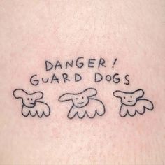 a tattoo that says danger guard dogs on it