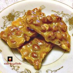 three pieces of pizza sitting on top of a white and gold plate covered in sauce