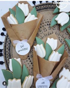 some decorated cookies are sitting on a plate with flowers in them and the words let s'moreatit written on it