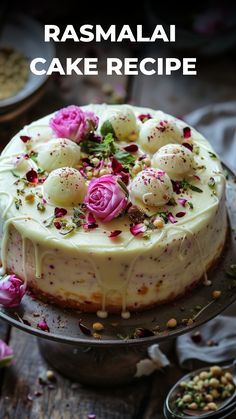 a cake with white frosting and pink flowers on top is sitting on a plate