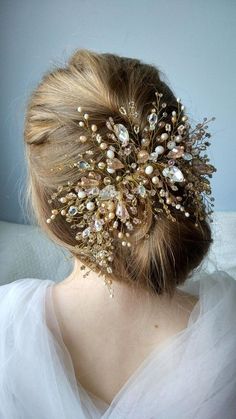 a close up of a woman wearing a hair comb with pearls and beads on it