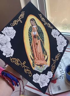 a graduation cap with an image of the virgin mary on it