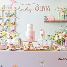 a table topped with lots of cakes and cupcakes