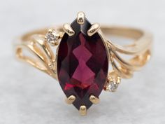 Unlock irresistible charm with this beautiful yellow gold bypass ring! Adorned with a marquise cut rhodolite garnet and dazzling diamond accents, it's sure to make everyone turn their heads! Seriously, don't bypass this ring. Get it now!Metal: 14K Yellow GoldGem: Rhodolite Garnet 1.73 CaratsGem Measurements: 6.1 x 11.9 mm, Marquise CutAccents: 2 Diamonds totaling .02 Carats, SI in Clarity, G-H in ColorRing Size: 6Marks: "14K" Stamped on the inside band Rhodolite Garnet Ring, Garnet And Diamond Ring, Bypass Ring, Birthday Ring, Ring With Diamond, Garnet Ring, Rhodolite Garnet, Pretty Rings, Garnet Rings