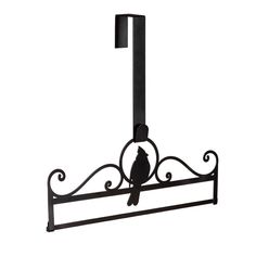 a bird is perched on top of a wrought iron towel rack that holds a towel