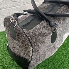 This stunning unique cowhide weekender duffel bag is a must-have for any traveler. Crafted from the highest quality grey and white leather, it's both luxurious and stylish. - Real cowhide interior. - Color: light grey white cowhide. - Leather, Zipper and Detailing. - Zipper Pocket Inside and Zip top closure on main compartment. - Fully lined interior - Extendable shoulder strap - The size is approx : 22(L) x9 (H) x 10(W) inches. - Handle to Carry on Shoulders - Care Instructions: Wipe clean with Leather Duffel Bag, Leather Weekender, Leather Duffel, Cowhide Bag, Patchwork Bags, Overnight Bag, Leather Zipper, Perfect Bag, Beautiful Bags