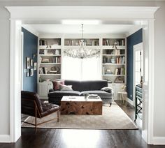 a living room filled with furniture and a chandelier