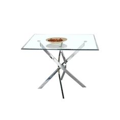 a glass table with a bowl of food sitting on it's base and two crossed legs