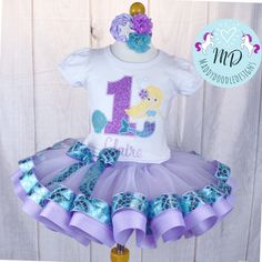 Mermaid Appliqué Ribbon trimmed Tutu outfit.  Will put birthday number 1-9 message with name birthday number and for change of colors. Outfits are made by order. Embroidered Birthday shirt.  TMembroidery offers quality customized products for your little one to wear. Name personalization added to the front of your design is free with your shirt. And we can customize further with different fabrics and colors just ask before ordering and we can send some ideas over. We are currently offering white Fitted Short Sleeve Sets For Birthday, White Short Sleeve Birthday Set, White Short Sleeve Sets For Birthday, Playful White Sets For Birthday, Cute Short Sleeve Sets For Birthday, Cute Blue Sets For Birthday, Fitted Blue Top For Birthday, Blue Fitted Top For Birthday, Customizable White Sets For Birthday