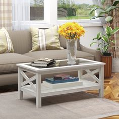 a white coffee table with yellow flowers on it