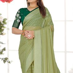 Pista Green colored saree is made from chiffon fabric which is highlighted with beautiful zari weaving striped pattern as shown. comes along with unstitched sequins embroidered net blouse which you can customise as per your design/style. Occasion - You can wear this saree for festive and functions, outing and get-together. Note:- the actual product may differ slightly in color and design from the one illustrated in the images when compared with computer or mobile screen. Measurements: Saree : Chiffon : 5.5 Mtrs Blouse : Chiffon : 0.8 Mtr Material: Chiffon Stitch Type: Unstitched Country of Origin: India Care Guide: Dry Clean Traditional Chiffon Blouse For Eid, Bollywood Style Chiffon Blouse With Self Design, Pista Green Georgette Blouse Piece With Cutdana, Festive Pista Green Georgette Blouse Piece, Chiffon Saree With Self Design In Traditional Drape, Festival Pista Green Georgette Blouse Piece, Green Chiffon Saree For Wedding, Festive Green Chiffon Saree, Green Saree With Unstitched Blouse In Georgette