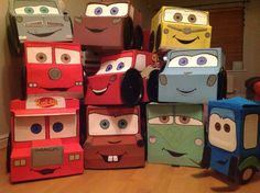 a pile of cardboard cars sitting on top of a hard wood floor