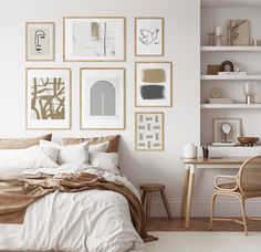 a bedroom with white walls and pictures on the wall