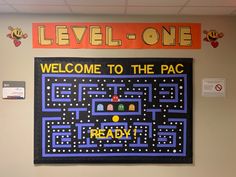 a sign that says, welcome to the pac - man game ready on a bulletin board