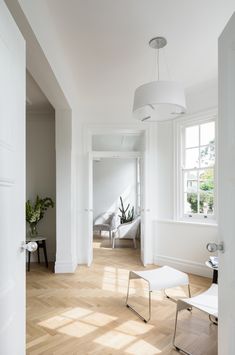 an empty room with white walls and wood flooring is pictured in this image from the doorway